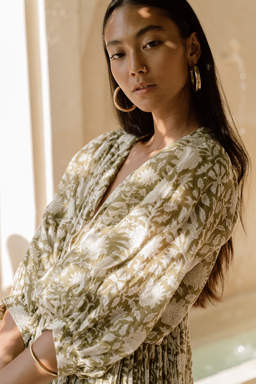 Daughters of India Kyra Midi Dress in Olive — close-up V-neckline with gold hoop earrings, hand screen print detail