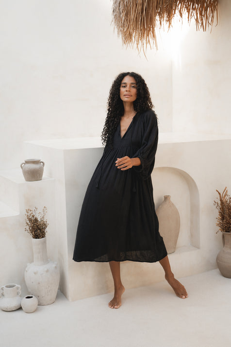 Daughters of India Kyra Midi Dress in Black Gauze — full length by white wall with ceramic pots, cotton gauze